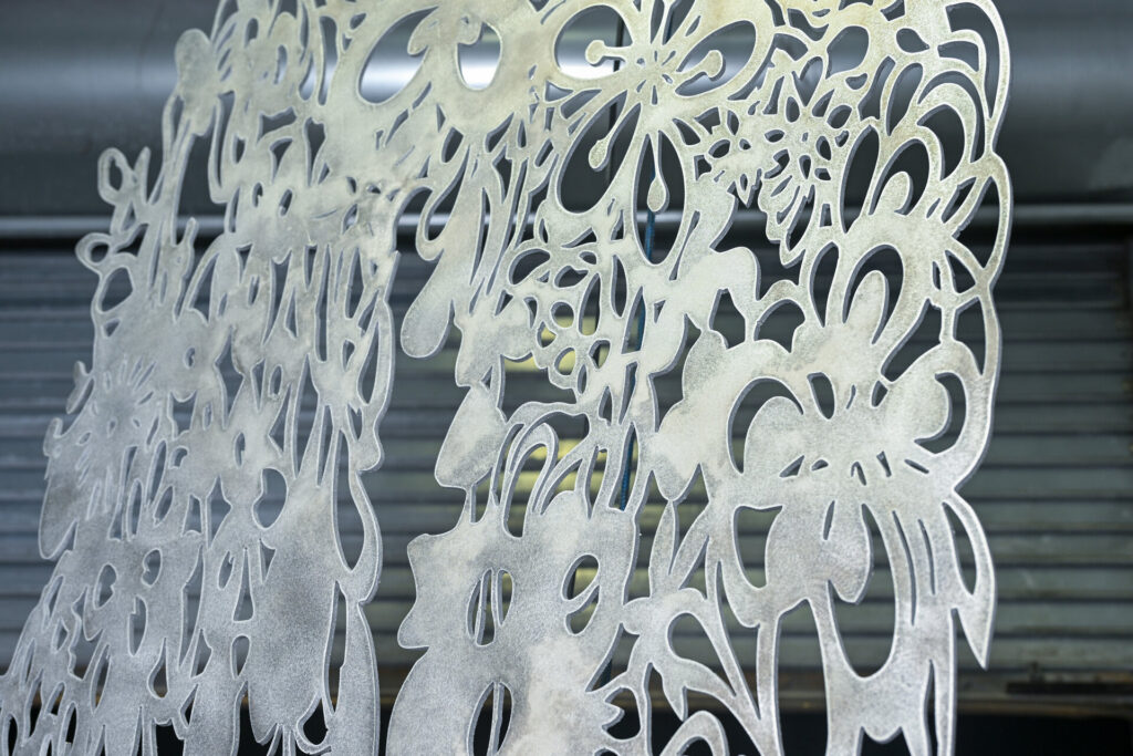 Water jet cut decorative metal panel — precision cutting vs plasma — Thor Metal Art Miami
